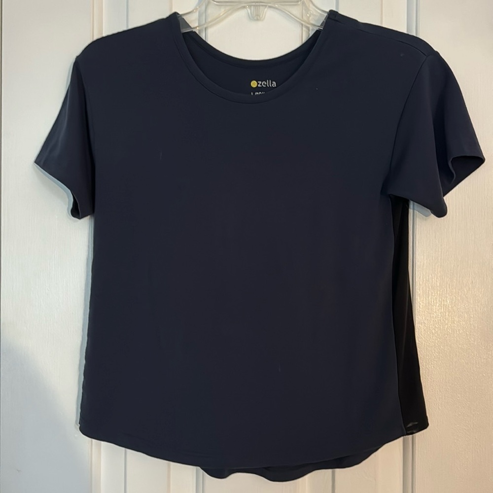 Zella dark blue top with short sleeves, is sheer on sides like wicking mesh
